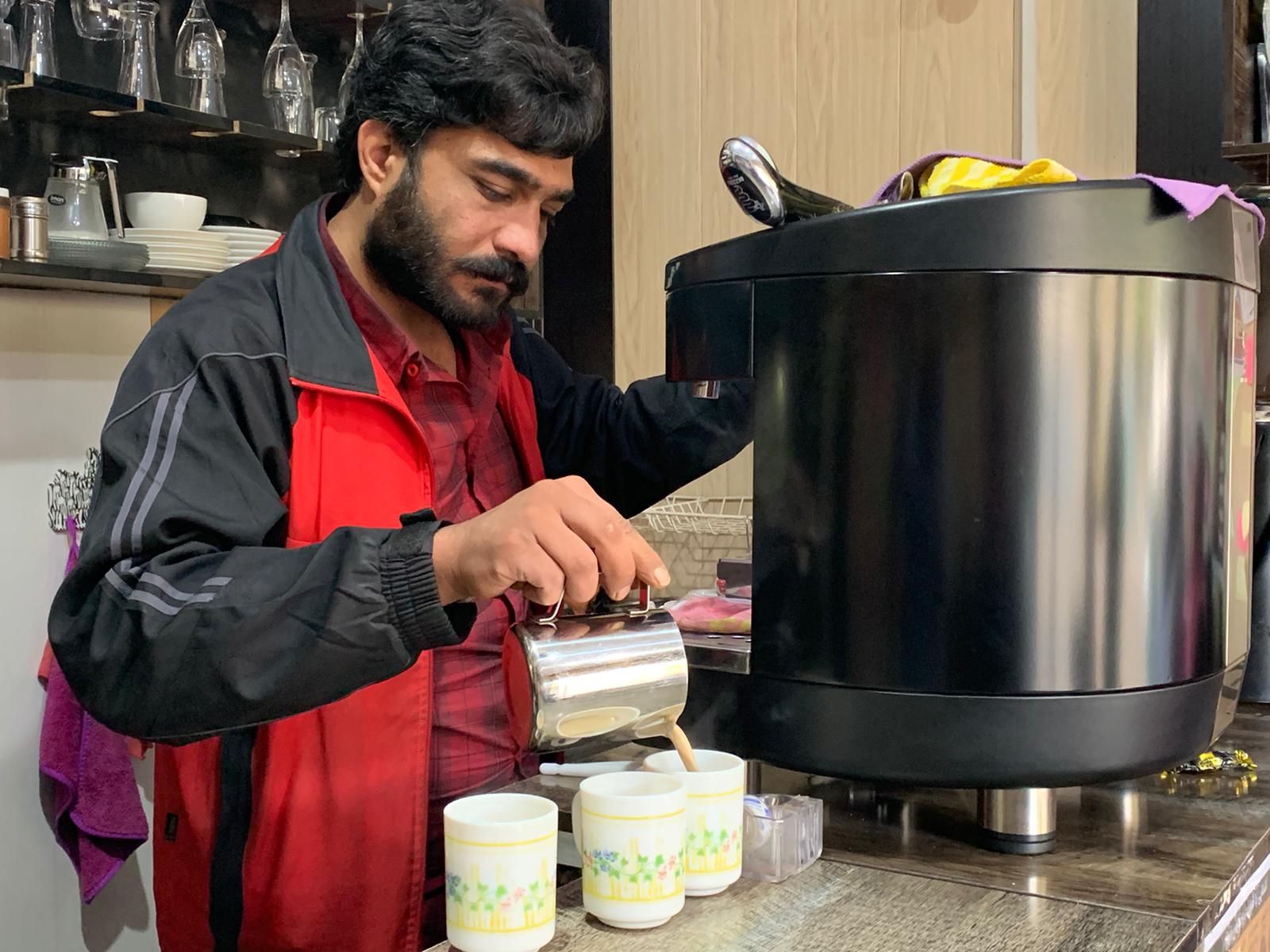 Iranian man serving coffee