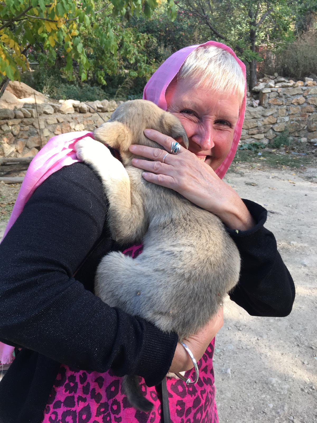 Lynn hugging a dog