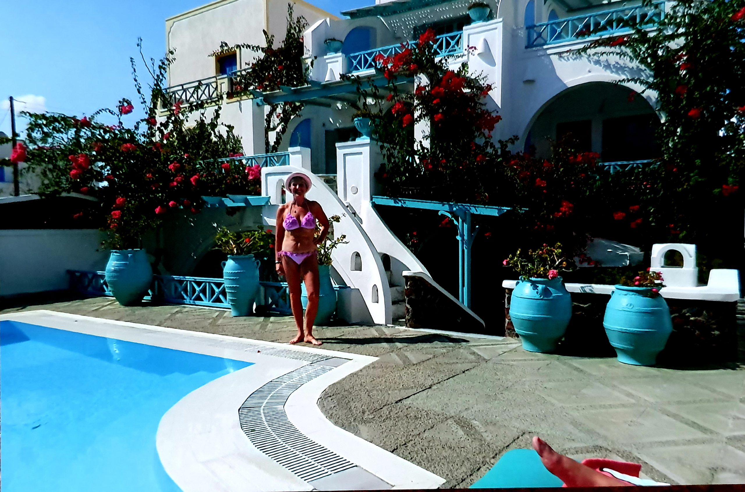 Lynn at the swimming pool on her trip to santorini
