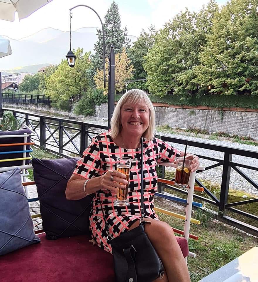 Me having a cocktail and a beer by the river in Peja