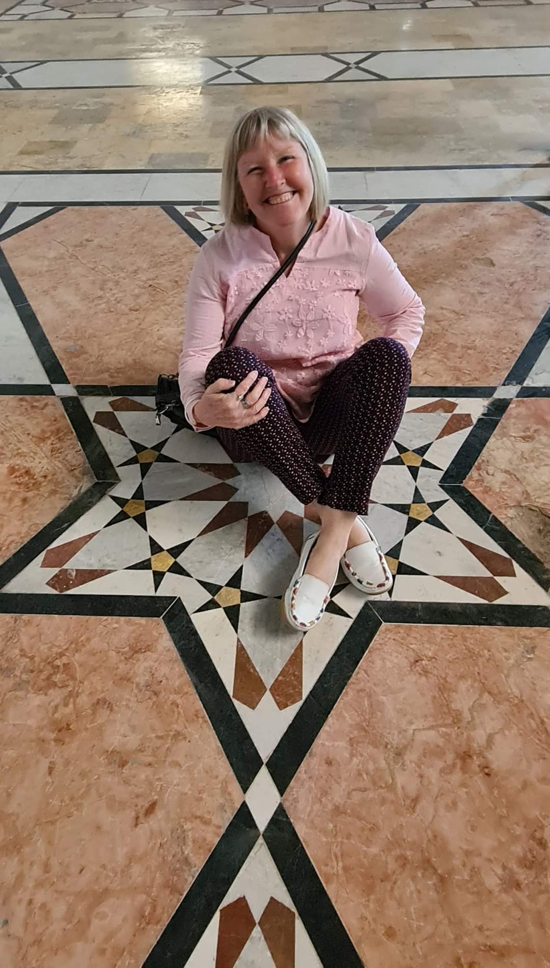 Me sitting on a beautiful floor in the hall of Aleppo castle