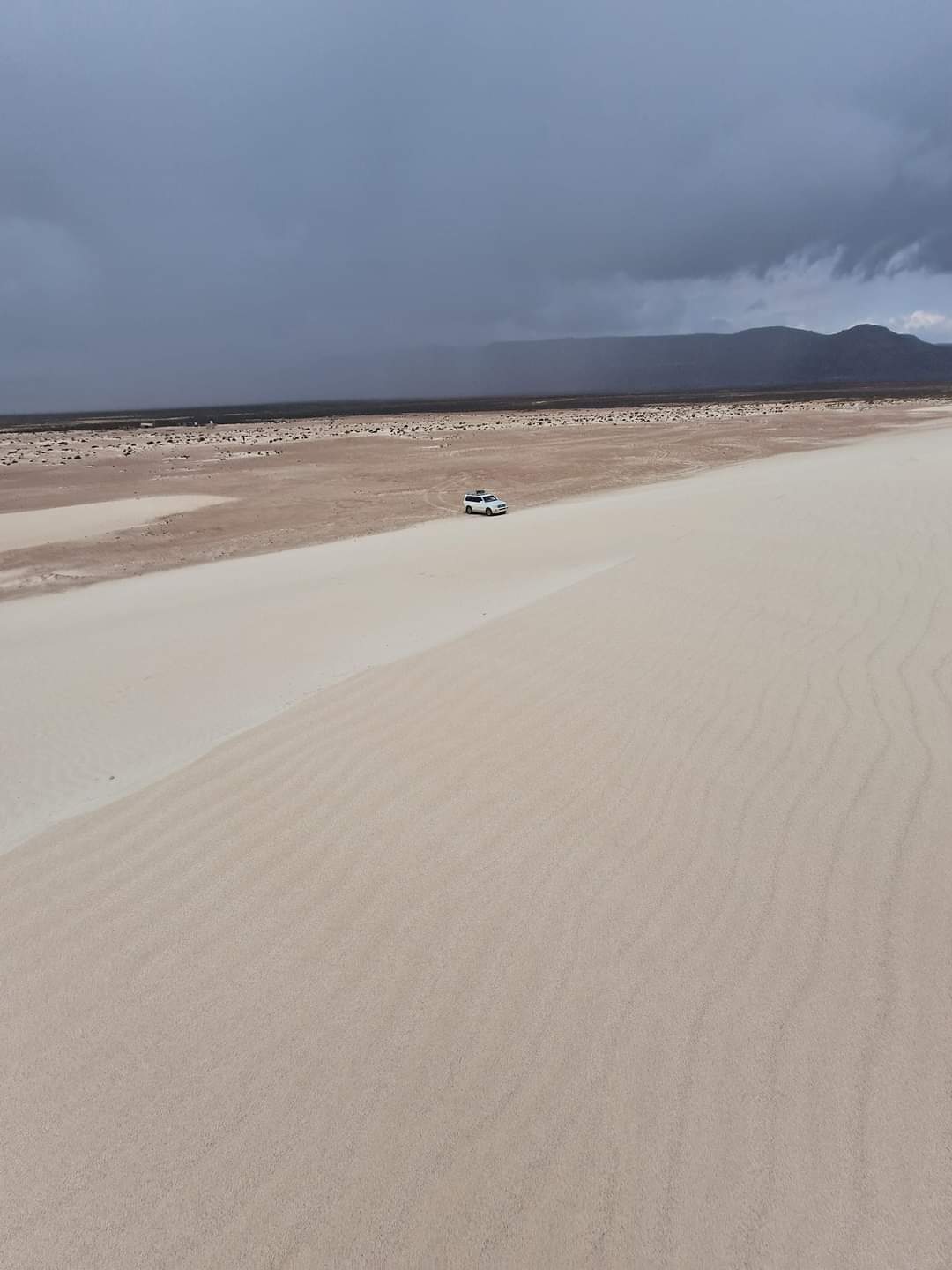 Our car dwarfed by Zehj sand dune