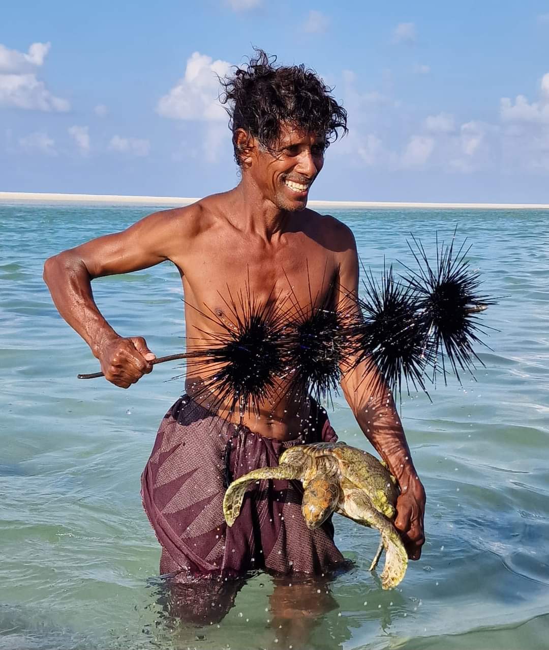 The caveman with sea urchins and a lobster in Socotra